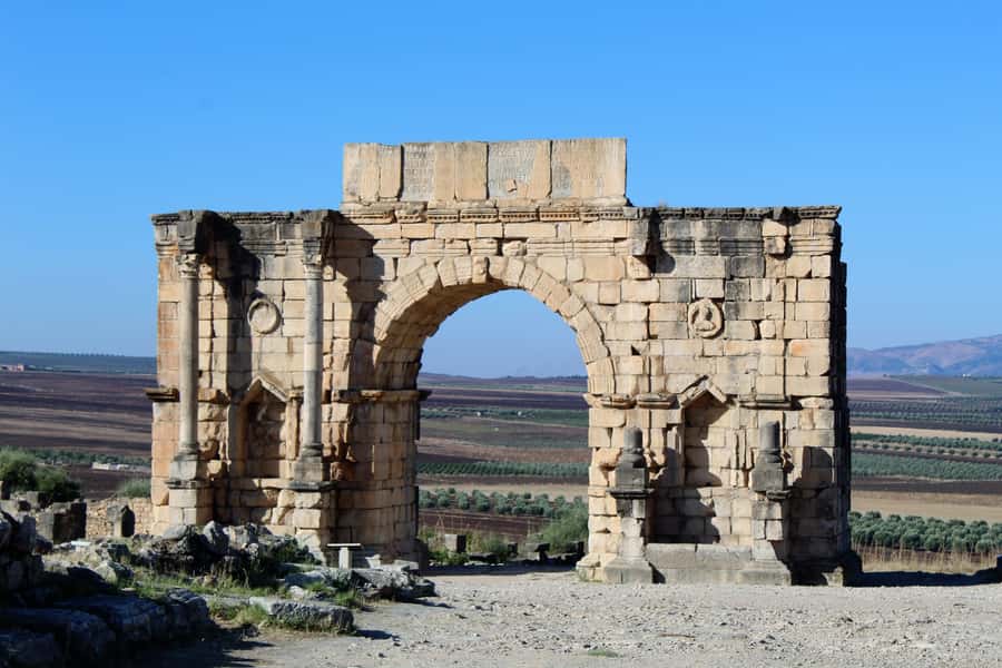 From Fez: Volubilis Moulay Idriss and Meknes Day Trip - Volubilis: Roman stones under open sky