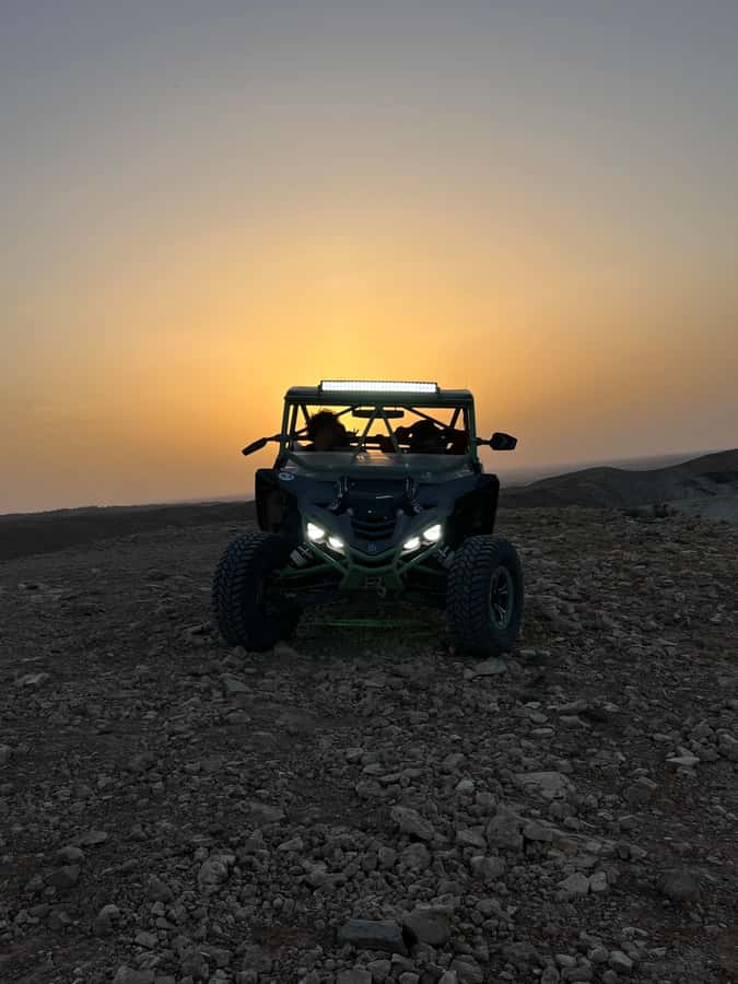 From Marrakech: Agafay Desert Buggy 1Hour & Dinner Show - Sunset over a rocky desert