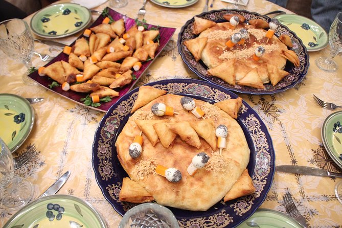 Join Best Moroccan Cooking Class with Chef Khadija ( Over 35 years Experience ) - Tagine, bread, and vegetable dishes at the table