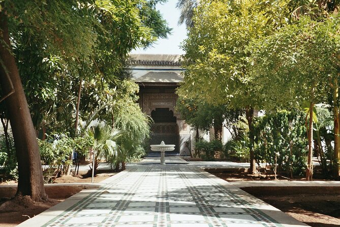 Marrakech Day Trip with Camel Ride from Casablanca - Walking through the Secret Garden and old gates