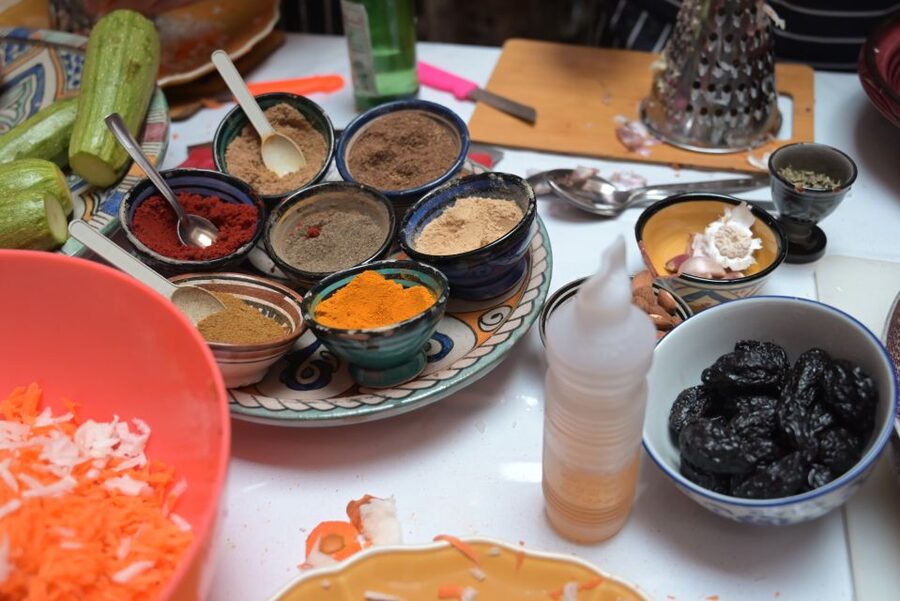 Marrakech: Moroccan Cooking Class with a Local Family - Building the main dish in a tagine