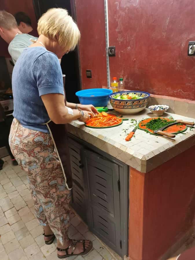 Marrakech: Moroccan Cuisine Cooking Class in Local Home - The first cooking tasks: bread, chopping, and Moroccan preparation