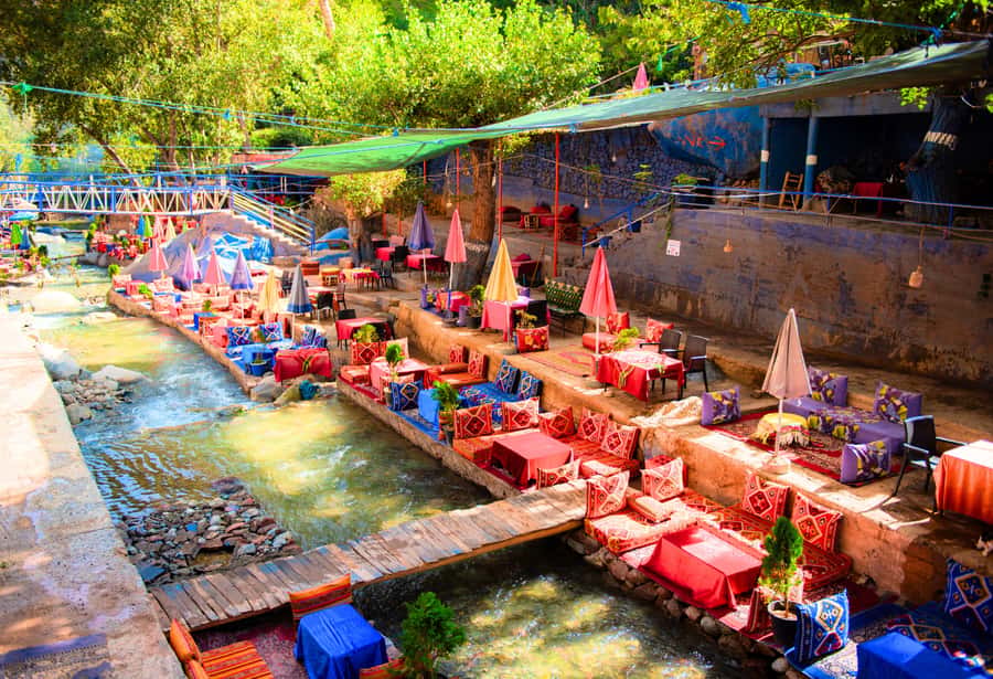 Marrakech: Ouzoud Waterfalls Trip, Guide & Boat + Lunch - The wooden boat beneath the cascades